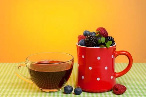 Cup with berries on the table Stock Photos