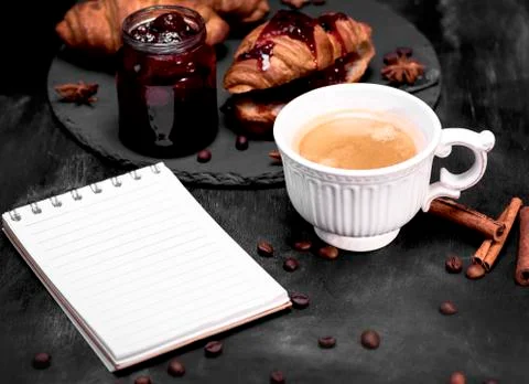 Cup with black coffee and an empty paper notebook Stock Photos