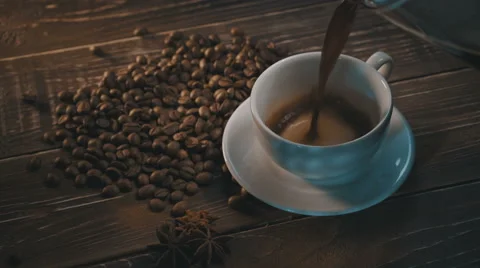 Cup of black coffee with beans over grunge wooden table Stock Footage 65794684
