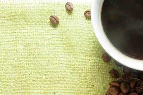 The cup of black coffee with coffee beans with wooden spoon. White background Stock Photos