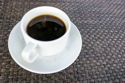 A cup of black coffee on the dining table in the morning. Stock Photos