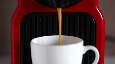 Cup of  black coffee made with a red coffee espresso machine - close up - Stock Footage 238993823