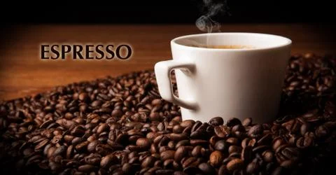 Cup of black coffee with roasted coffe beans 库存照片