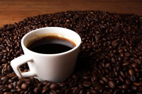 Cup of black coffee with roasted coffe beans Stock Photos