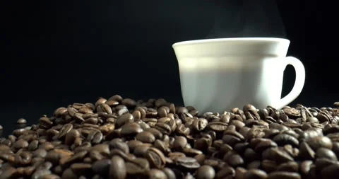 Cup of black coffee with roasted coffee beans on black background. Stock Footage 145132398