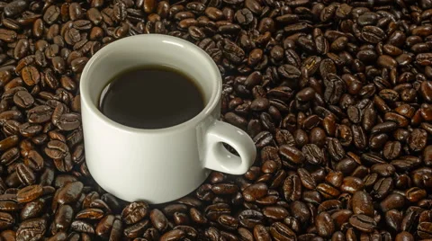 Cup of black coffee rotation on the background of roasted coffee beans 4K Stock-Footage 46525723