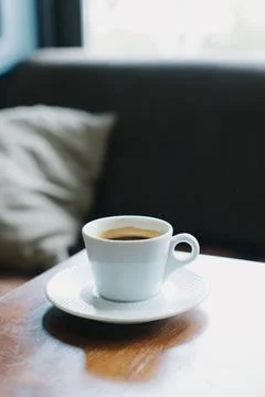 Cup of black coffee on a table in a cafe. Selective focus. Stock Photos