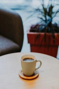 Cup of black coffee on a table in a cafe. Stock Photos