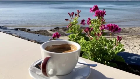 Cup of black freshly made coffee on beach Stock Footage 154326064