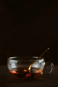 Cup of black tea on dark background, selective focus, low key still life phot Stock Photos