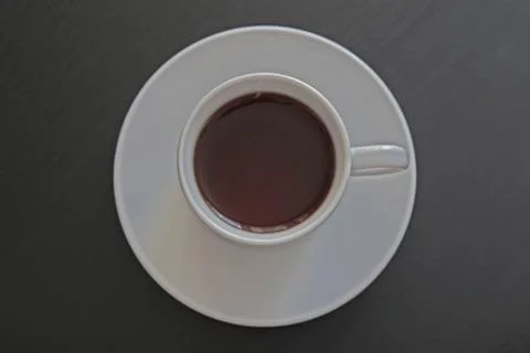 Cup of black tea on gray background Foto stock
