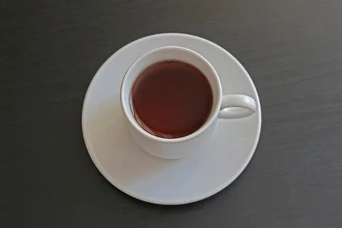 Cup of black tea on gray background Stock Photos