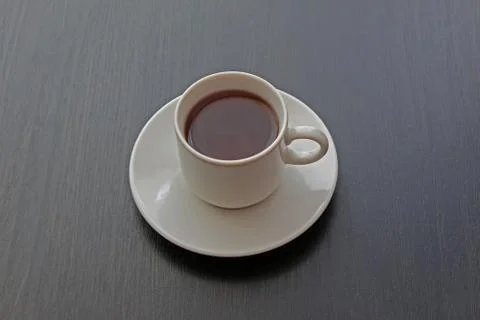 Cup of black tea on gray background Stock Photos