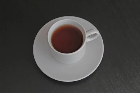 Cup of black tea on gray background Stock Photos