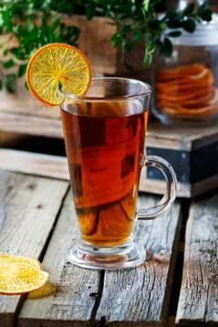 Cup of black tea with a slice of dried orange Stock Photos