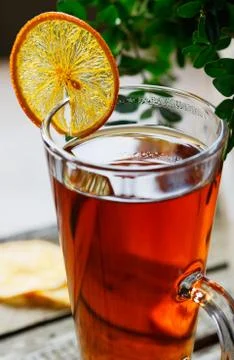 Cup of black tea with a slice of dried orange Stock Photos