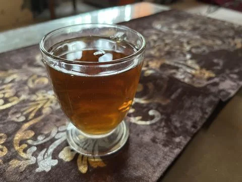 A cup of black tea on the table Stock Photos