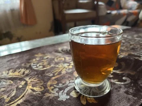 A cup of black tea on the table Stock Photos