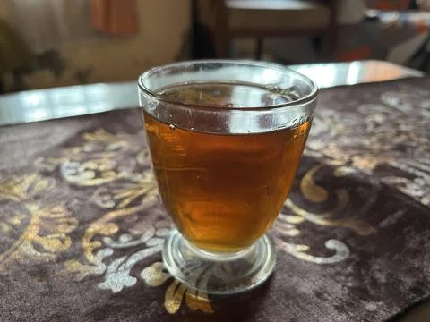A cup of black tea on the table Stock Photos
