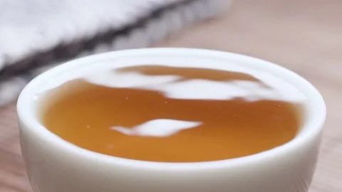A cup of black tea, the tea dripping close up Vídeo Stock 234501399