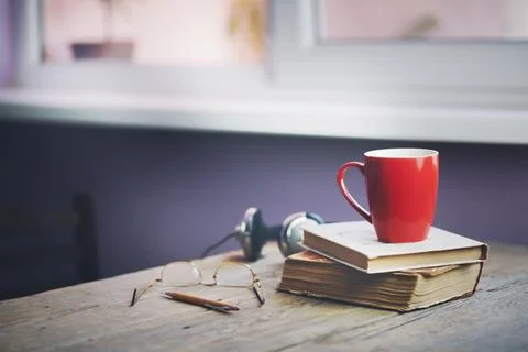 Cup on book Stock Photos