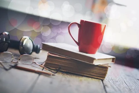 Cup on book Stock Photos