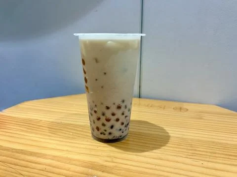 A cup of bubble tea on a wooden table. Stock Photos