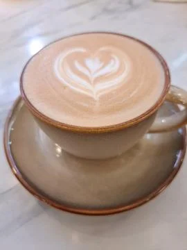 A Cup of Caffe Latte with Heart Latte Art on Marble Table Stock Photos