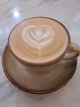 A Cup of Caffe Latte with Heart Latte Art on Marble Table Stock Photos