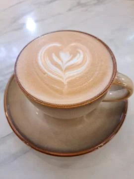 A Cup of Caffe Latte with Heart Latte Art on Marble Table Stock Photos