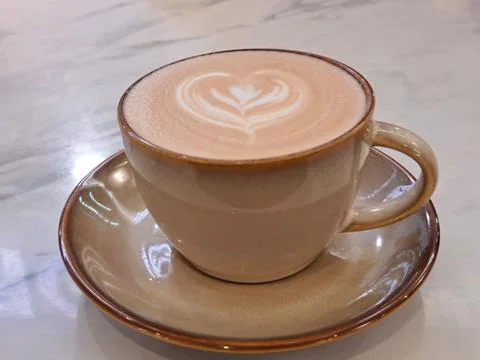 A Cup of Caffe Latte with Heart Latte Art on Marble Table Stock Photos