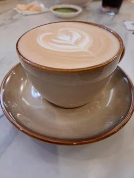 A Cup of Caffe Latte with Heart Latte Art on Marble Table Stock Photos