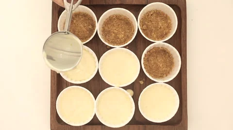 Cup cake base being spread with cream cheese Stock Footage 51936595