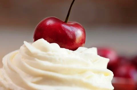 Cup cake topping with cherry Stock Photos