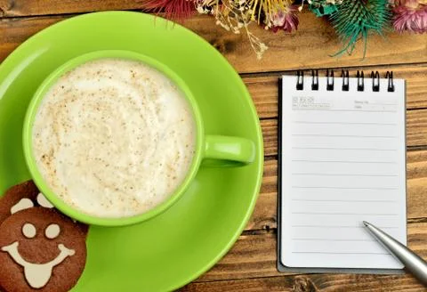 Cup with cappuccino and empty notebook Stock Photos