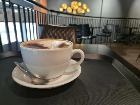 Cup of cappuccino on cafe table Stockfoto's