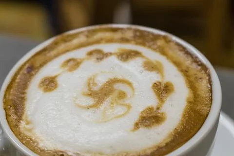 The cup of cappuccino with a decorative pattern Stock Photos