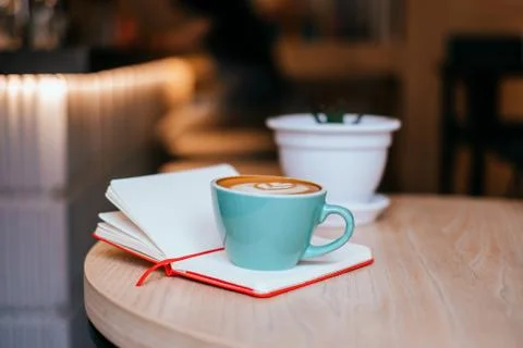 Cup of cappuccino with notebook Stock Photos