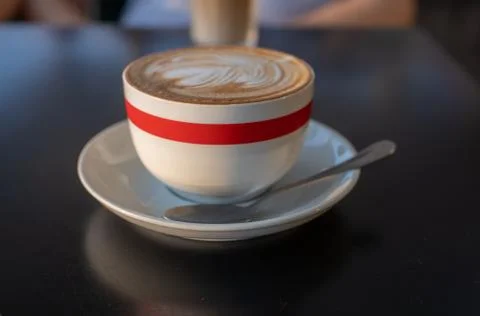 A cup of cappuccino with a spoon Stock Photos