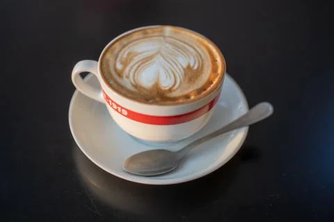 A cup of cappuccino with a spoon Stock Photos