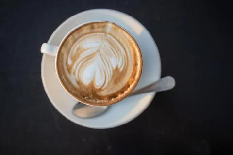 A cup of cappuccino with a spoon Stock Photos