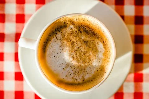 A Cup of cappuccino is on the table in the cafe 写真素材