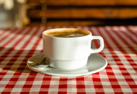A Cup of cappuccino is on the table in the cafe 写真素材