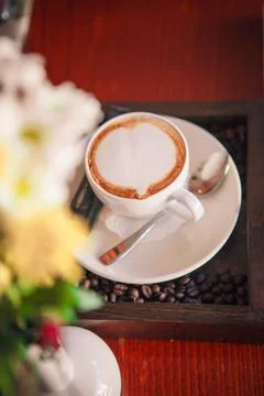 A cup of cappuccino on a table in a cafe Stock Photos