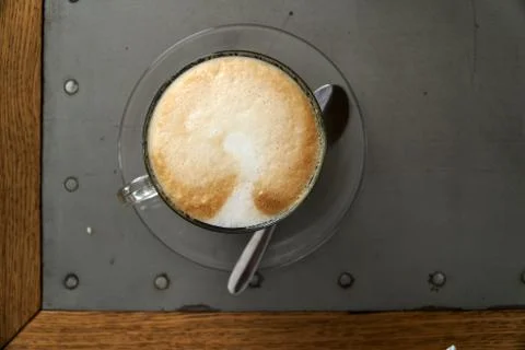 Cup of cappuccino on the table. Top view, macro. Loft table wooden and metal Stock Photos