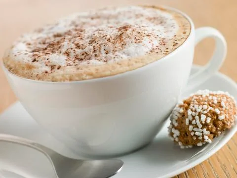 Cup of Cappucino with an Amaretti Biscuit Stock Photos
