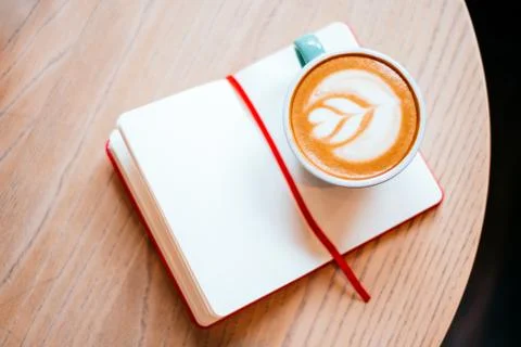 Cup of cappucсino with notebook Stock Photos