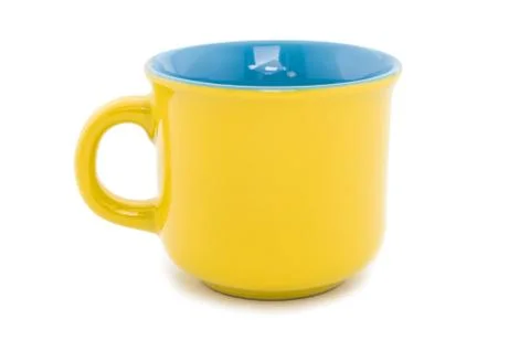 Cup the ceramic yellow. Stock Photos