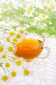 Cup of chamomile tea over white background Stockfoto's