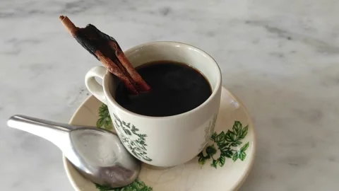 A cup of cinnamon coffee on a marble table Stock Footage 268130710